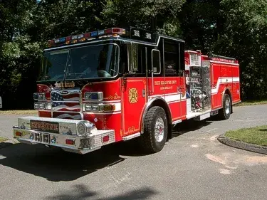 Pumper front-left exterior view showing enclosed cab and side compartments