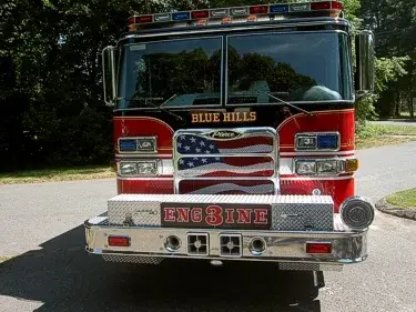 Front exterior view showing grille, bumper, and warning lights