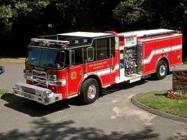 Front-left exterior view with open pump panel showing gauges and controls