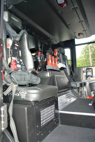 Cab interior view showing front seats, center console, and dashboard