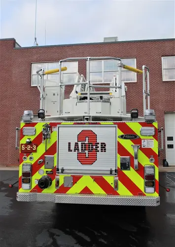 Rear view showing chevrons, rear compartment opening, and ladder base