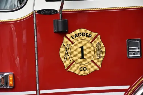 Cab door close-up showing circular ladder-company crest