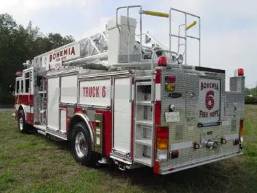 Rear-left exterior view showing rear body panel and ladder bed