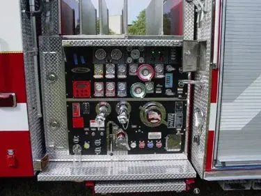 Pump panel close-up showing gauges, valves, and intake controls