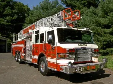 Tower ladder front-left exterior view showing enclosed cab and aerial sections