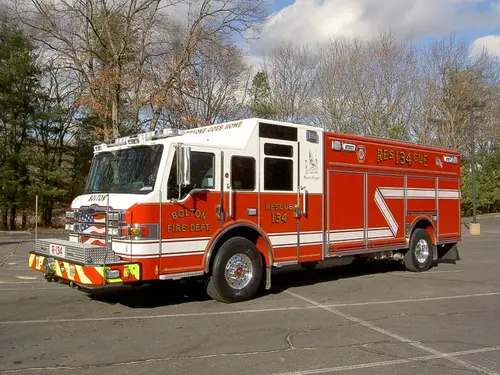Rescue pumper front-left exterior view showing enclosed cab and long body
