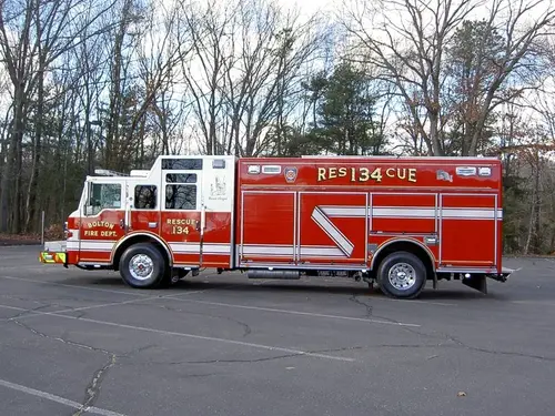 Driver-side full profile view showing long rescue body and wheelbase