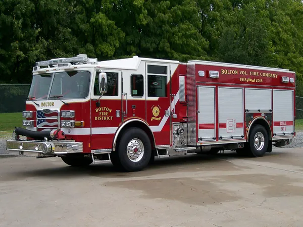 Pumper front-left exterior view showing enclosed cab and side compartments
