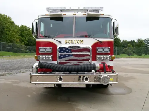 Head-on front view showing grille, bumper, and warning lights