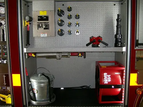 Open side compartment showing pump controls and lower storage bay