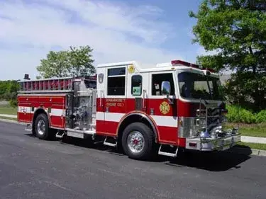 Pumper front-left exterior view showing enclosed cab and side body