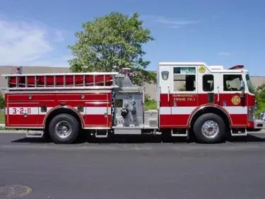 Driver-side full profile showing side compartments and rear wheel area