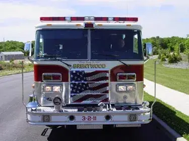 Head-on front view showing grille, bumper, and warning lights