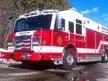 Wide front left view of the parked heavy rescue truck with bumper, cab, and full body length.