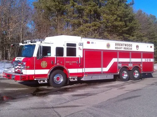 Full right-side profile showing the heavy rescue body layout and tandem rear axles.