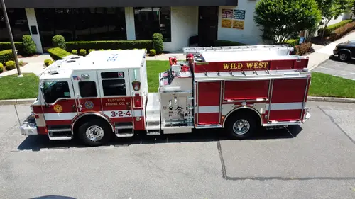 Pierce pumper aerial driver-side profile showing pump panel area and side compartments