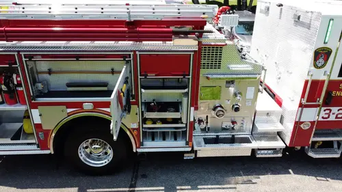 Pierce pumper aerial close-up of side pump panel area and open lower compartments
