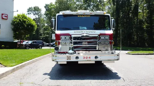 Pierce pumper front-left exterior view with cab and pump panel side visible