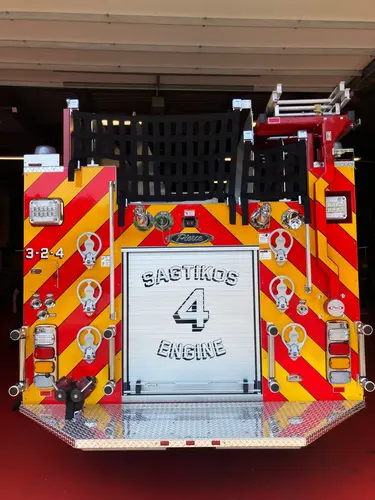 Pierce pumper driver-side profile in bay with closed roll-up compartment doors
