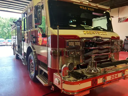 Pierce pumper head-on front view inside bay with warning lights and bumper intakes