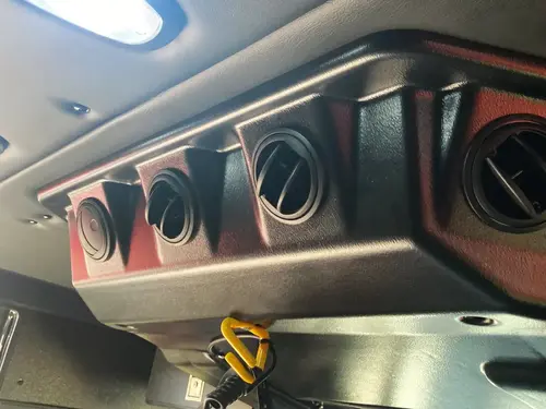 Cab interior panel close-up with rectangular latch and hardware
