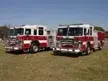 Two pumpers front-left lineup view showing cabs and front bumpers