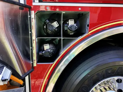 Wheel-well compartment close-up showing mounted couplings and utility fittings
