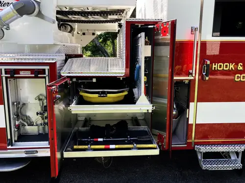 Officer-side wide view with multiple open compartments and slide-out platforms