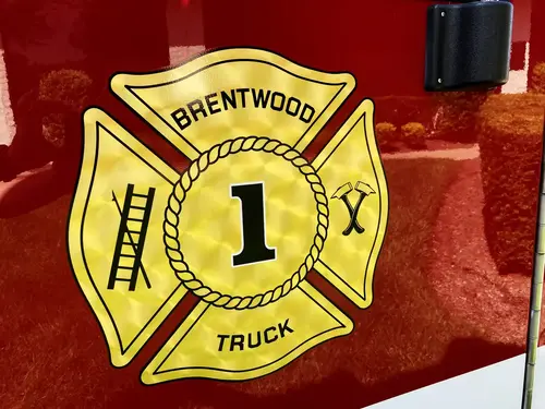 Pierce tower ladder front view showing grille, bumper, and warning lights
