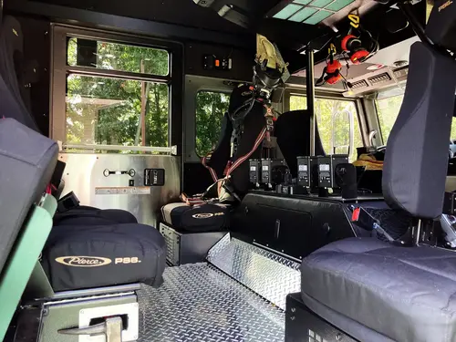 Rear crew seat row close-up with SCBA mounts and shoulder restraints