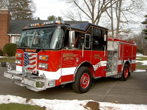 Pumper front-left exterior view in snow showing enclosed cab and side compartments