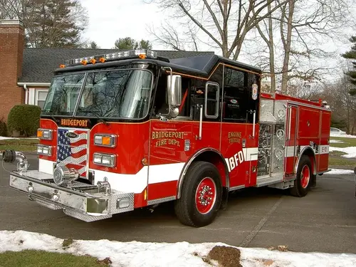 Pumper front-left exterior view in snow showing enclosed cab and side compartments