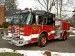 Pumper front-left exterior view in snow showing enclosed cab and side compartments