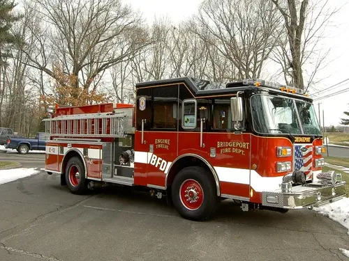 Driver-side profile view showing side hosebed rails and pump panel area