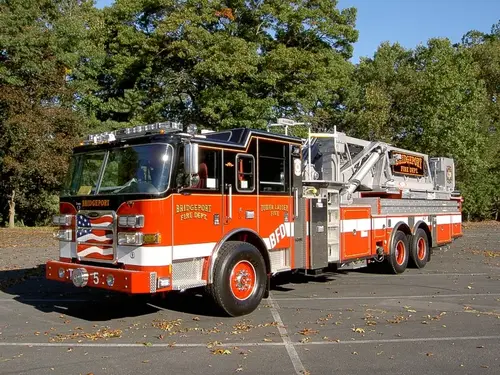 Tower ladder truck front-left exterior view showing aerial ladder sections