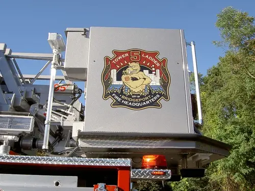 Bucket side close-up showing department crest on white panel