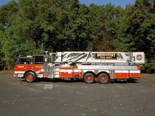 Driver-side full profile showing ladder bed and side body compartments