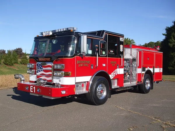 Pumper front-left exterior view showing enclosed cab and side compartments