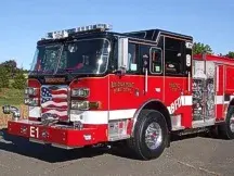 Front-left view showing open cab door, bumper, and side compartments
