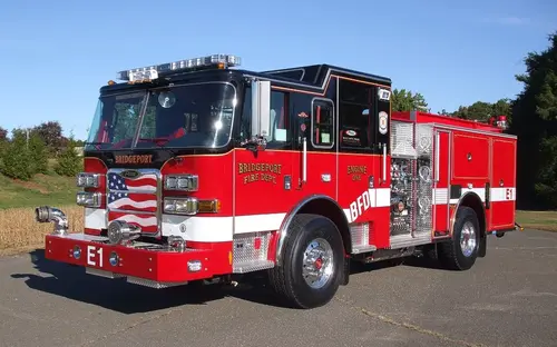 Front-left exterior view showing bumper, cab, and side compartments