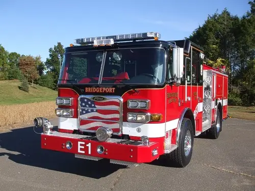 Front-left close view showing grille, bumper, and warning lights