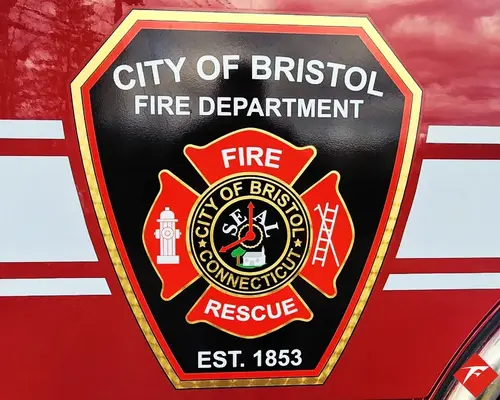 Cab door close-up showing city fire rescue crest on red paint