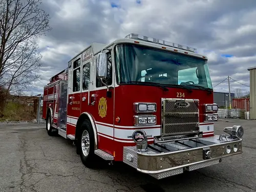 Pumper front-right exterior view showing chrome bumper, grille, and crew cab
