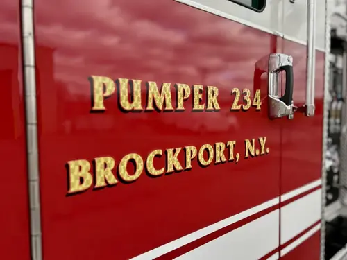 Cab door close-up showing pumper unit lettering and door handle