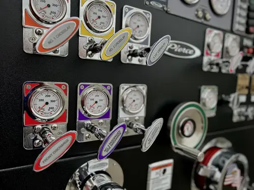 Pump panel close-up showing gauges, valve labels, and intake controls