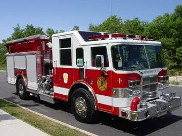 Pumper front-left exterior view showing enclosed cab and side compartments