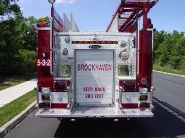 Rear view showing rear roll-up door, hosebed area, and warning lights