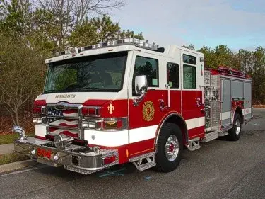 Pumper front-left exterior view showing enclosed cab and side compartments