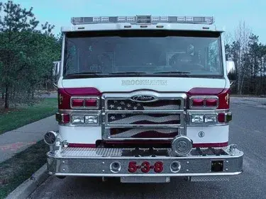Front exterior view showing grille, bumper, and warning lights