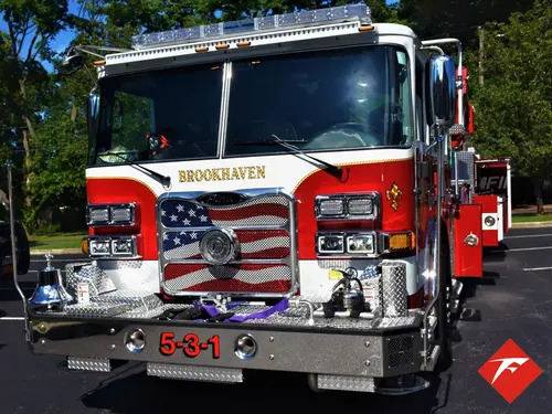 Head-on front view showing grille, bumper, and warning lights